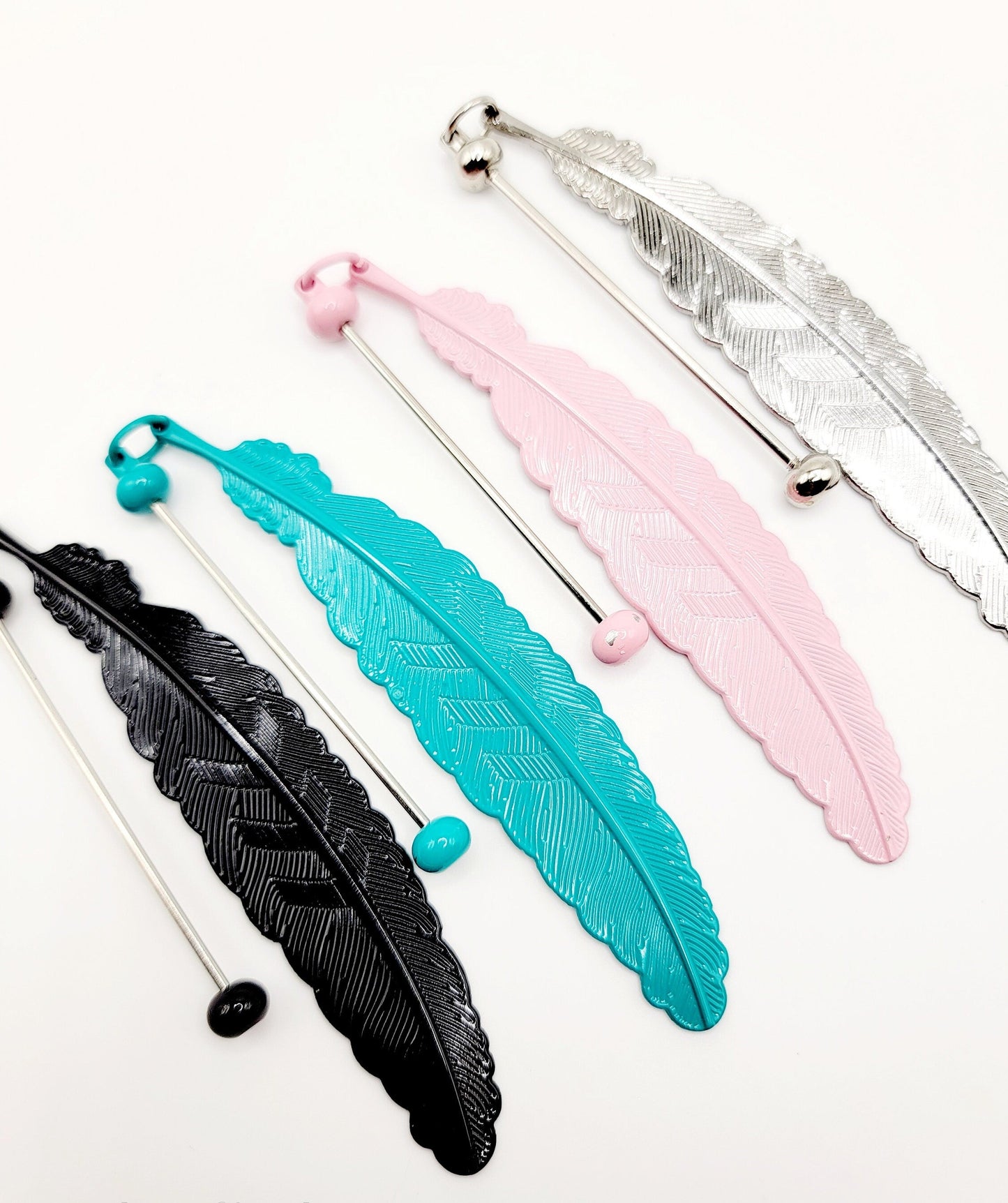 Colorful feather-shaped straws on a white background