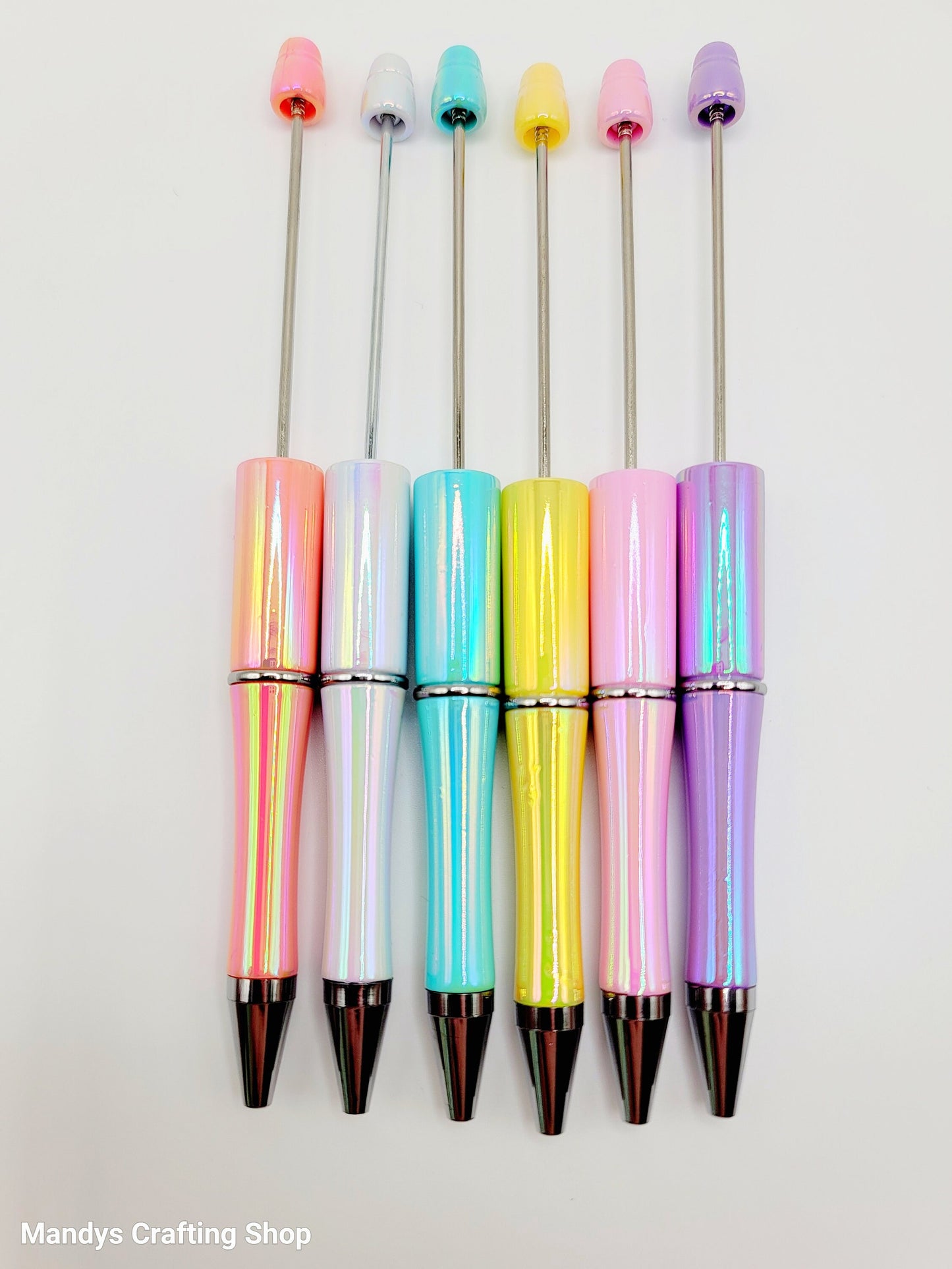 Set of colorful pens with pastel accents on a white background