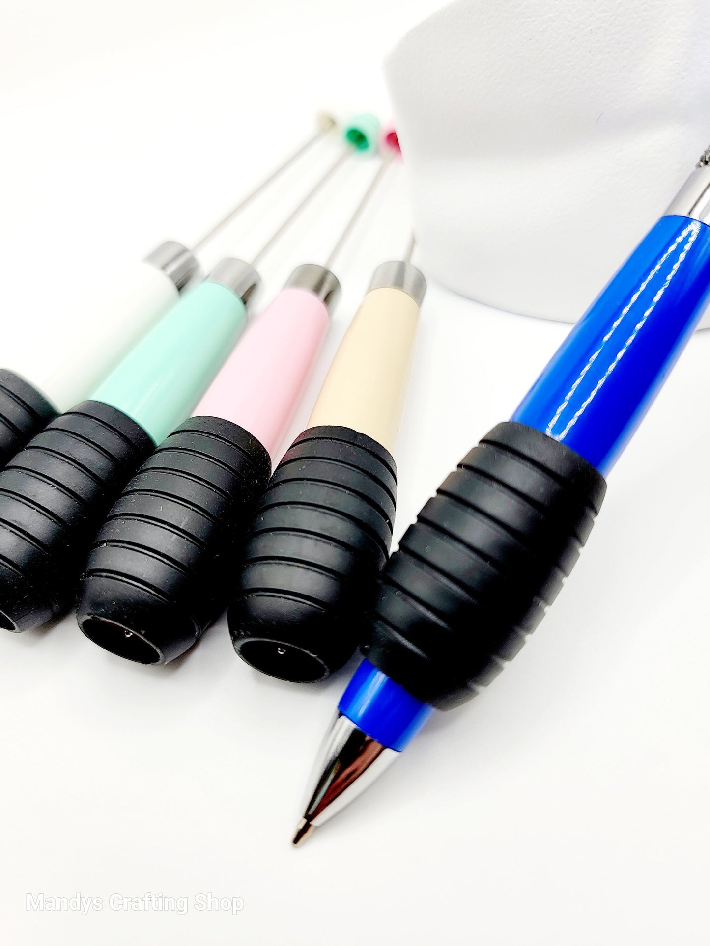 Set of colorful pens with ergonomic grips on a white background