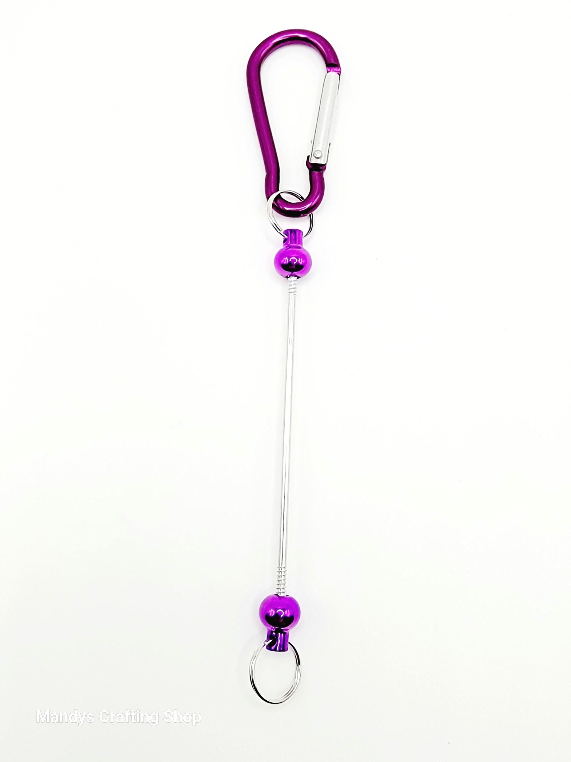 Purple carabiner with a long string on a white background