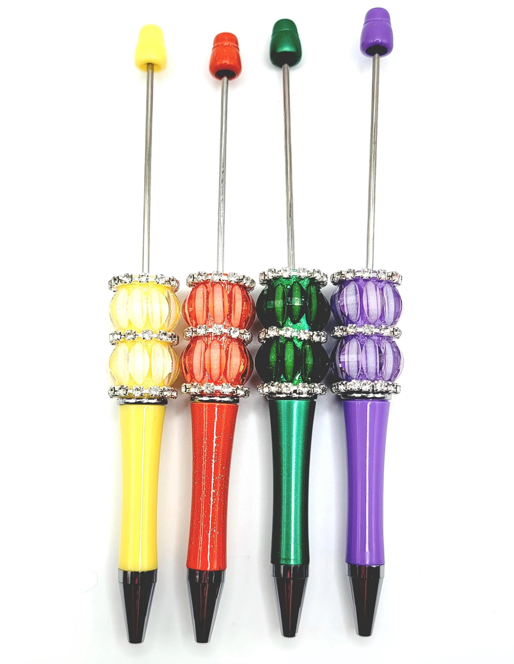 Set of four colorful pens with multicolored caps on a white background