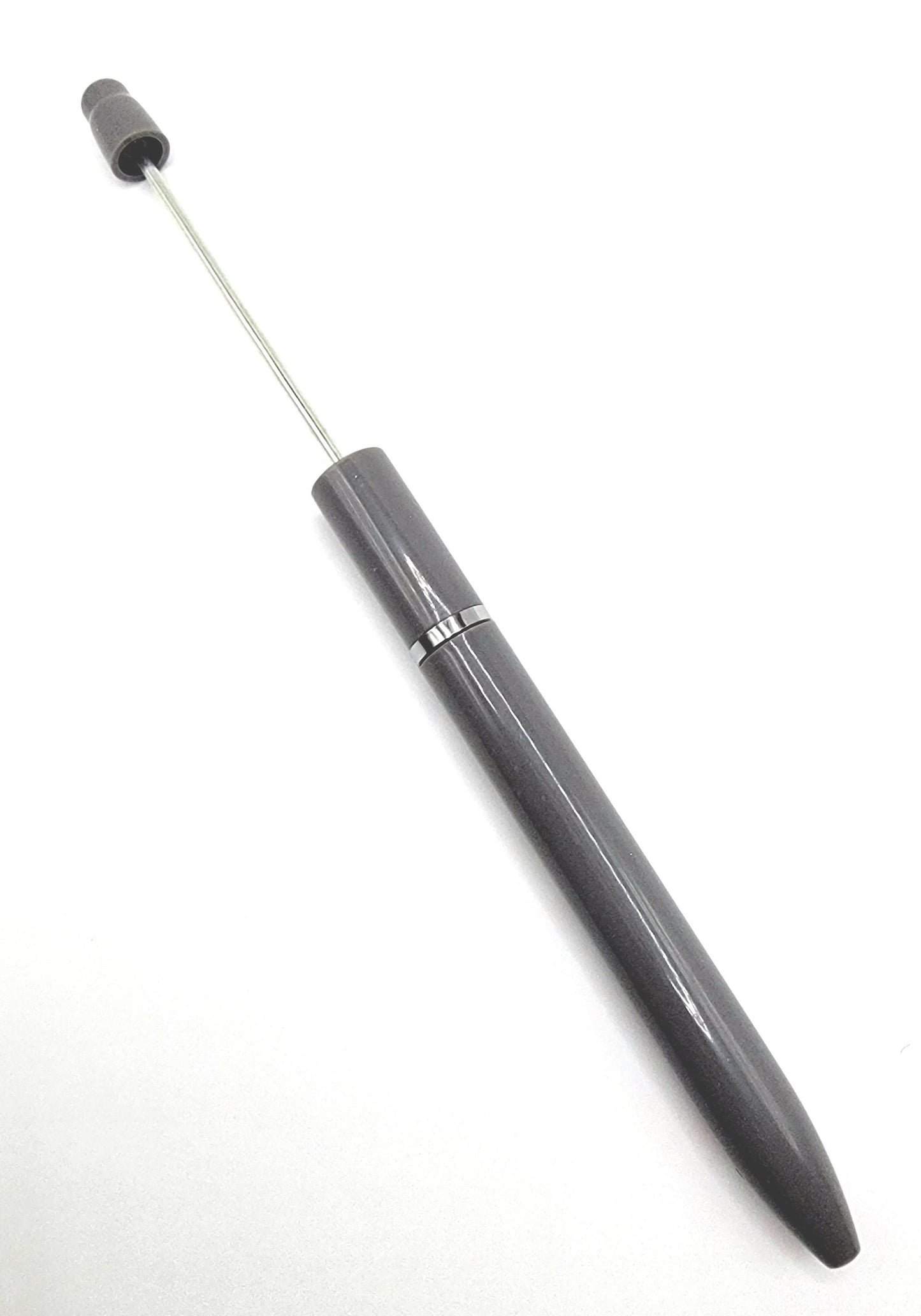 Gray pen with various colored caps on a white background