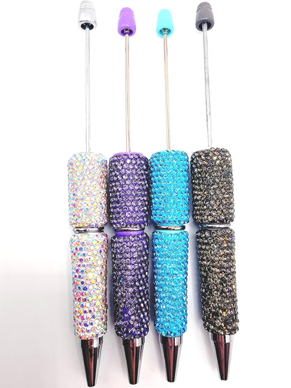 Set of five blinged-out pens with colorful accents on a white background