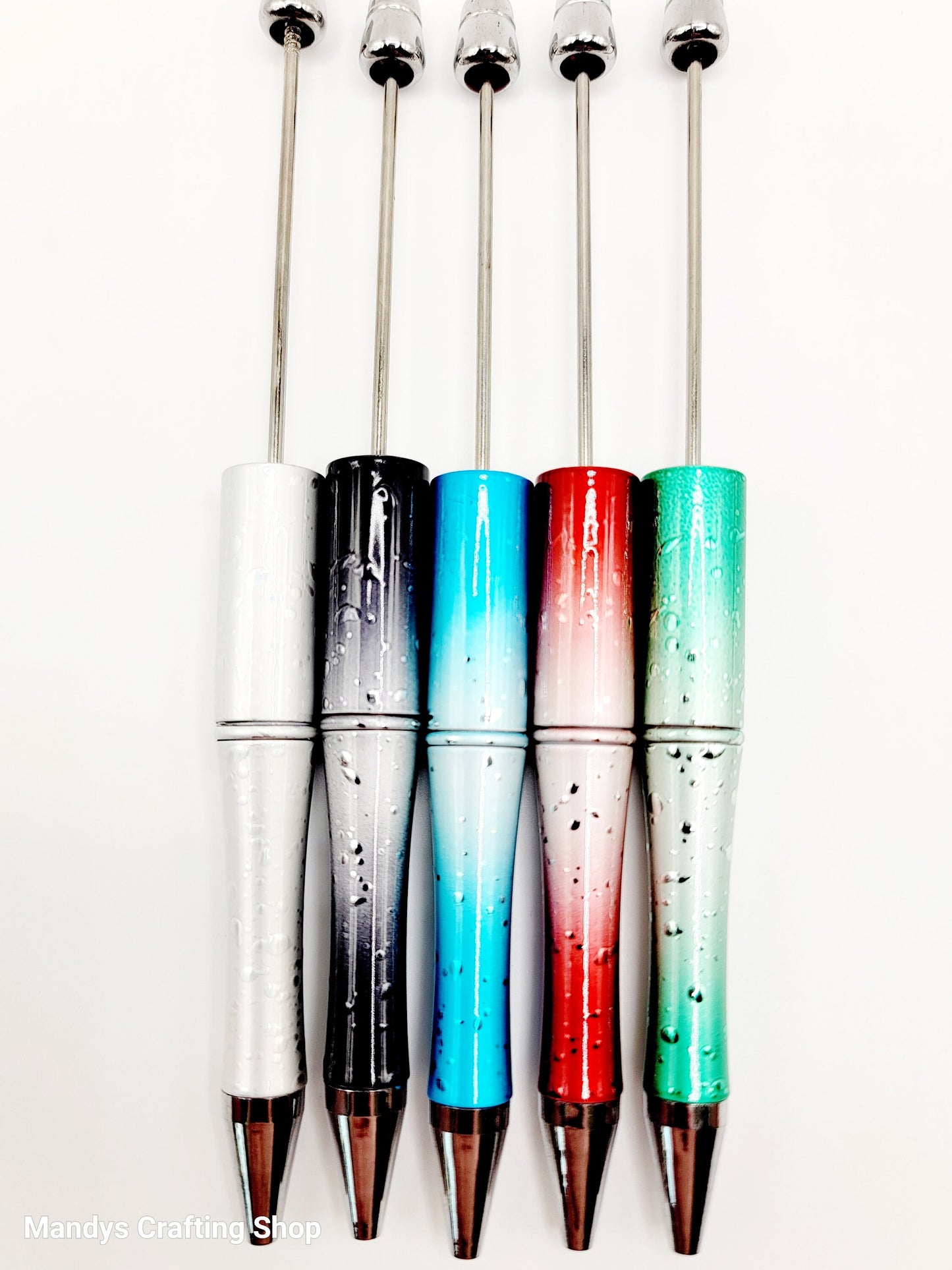 Set of colorful cocktail stirrers with gradient designs on a white background