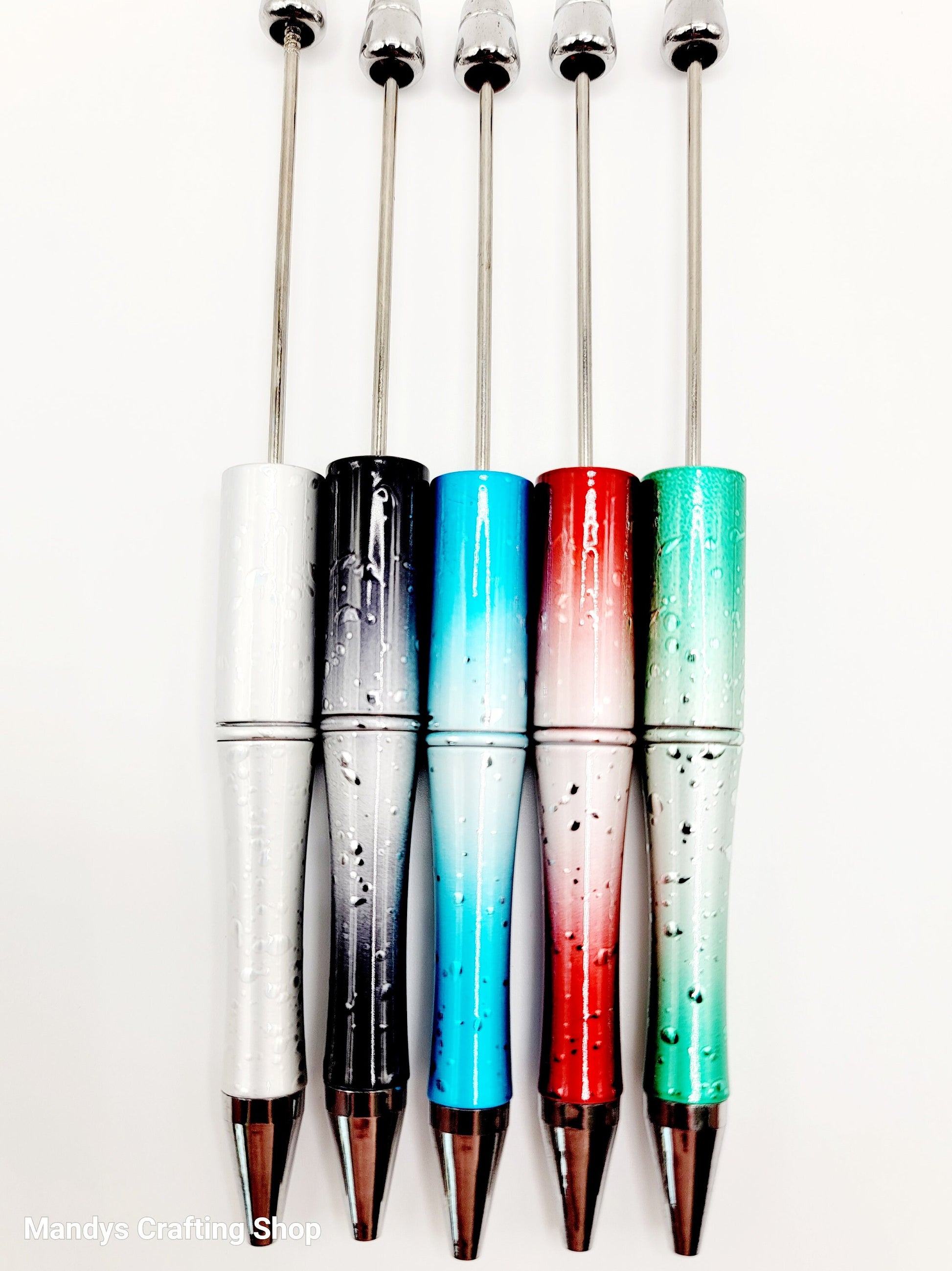 Set of colorful cocktail stirrers with gradient designs on a white background