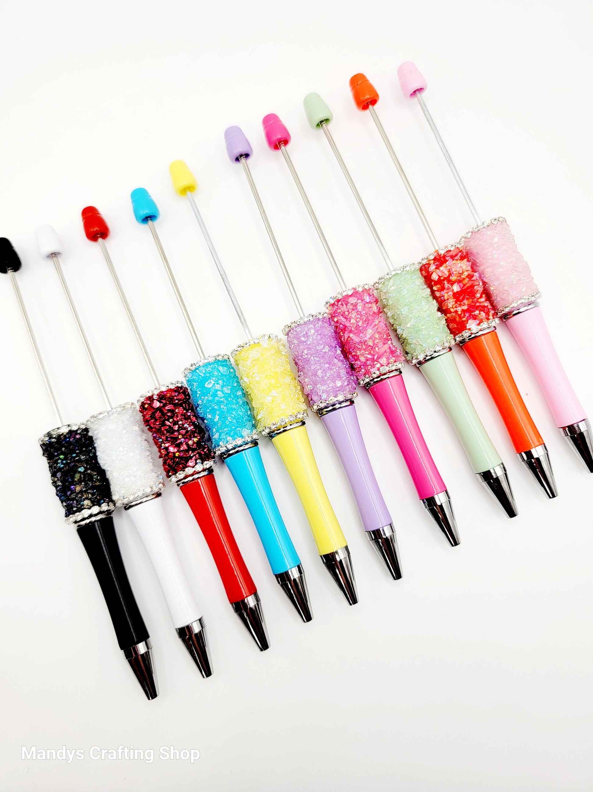 Colorful glittery pen set on a white background