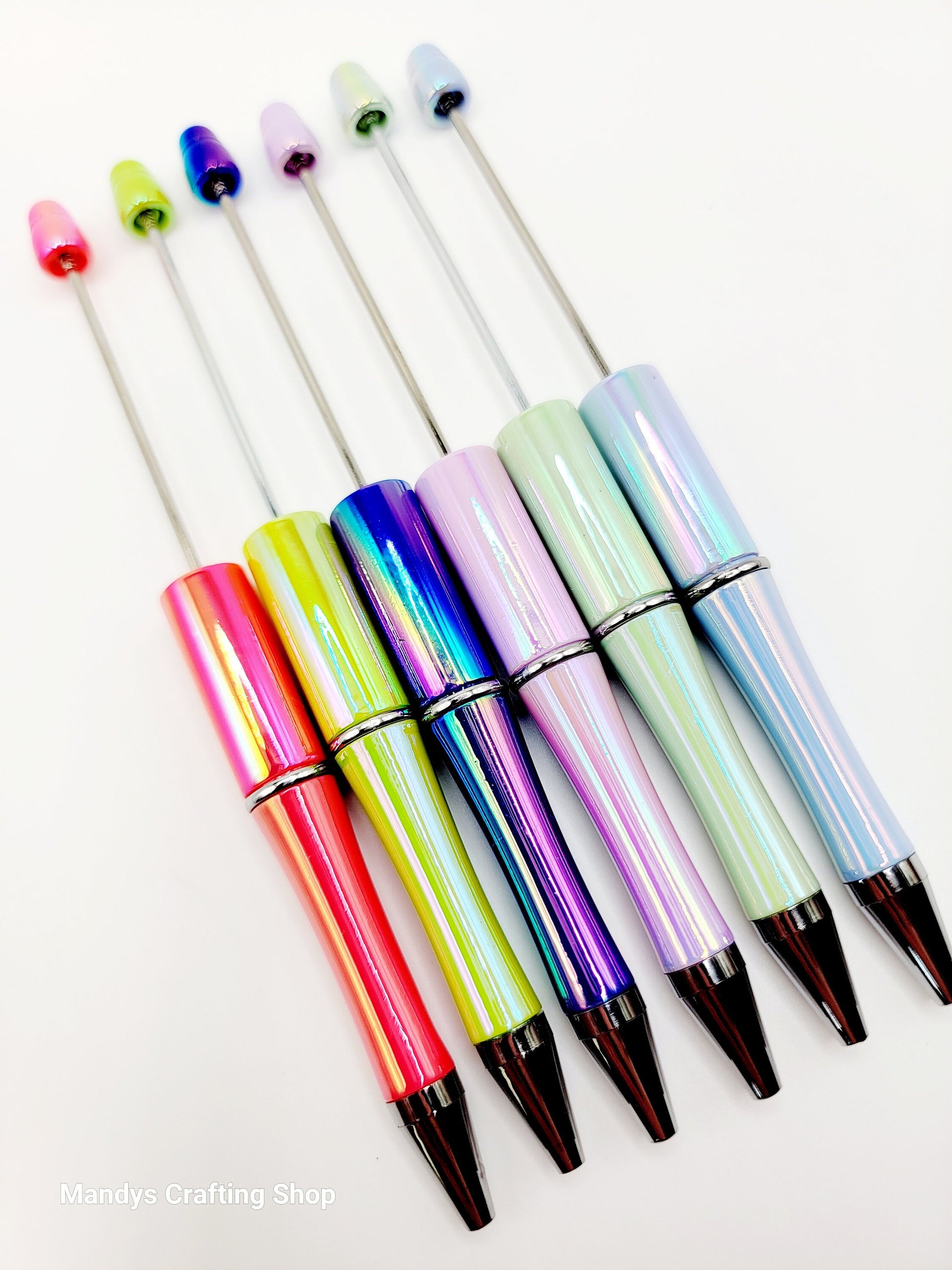 Set of colorful pens with multicolored caps on a white background