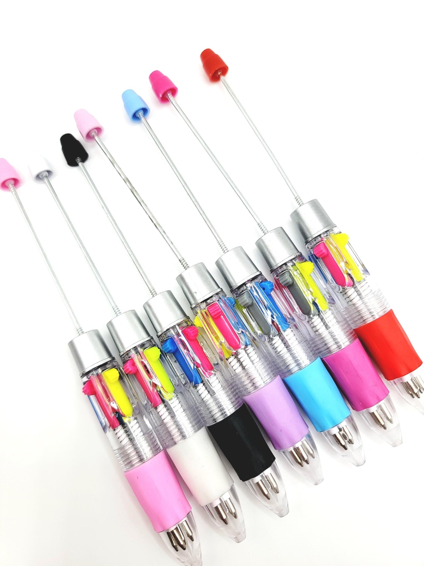 Set of colorful ballpoint pens with transparent bodies on a white background
