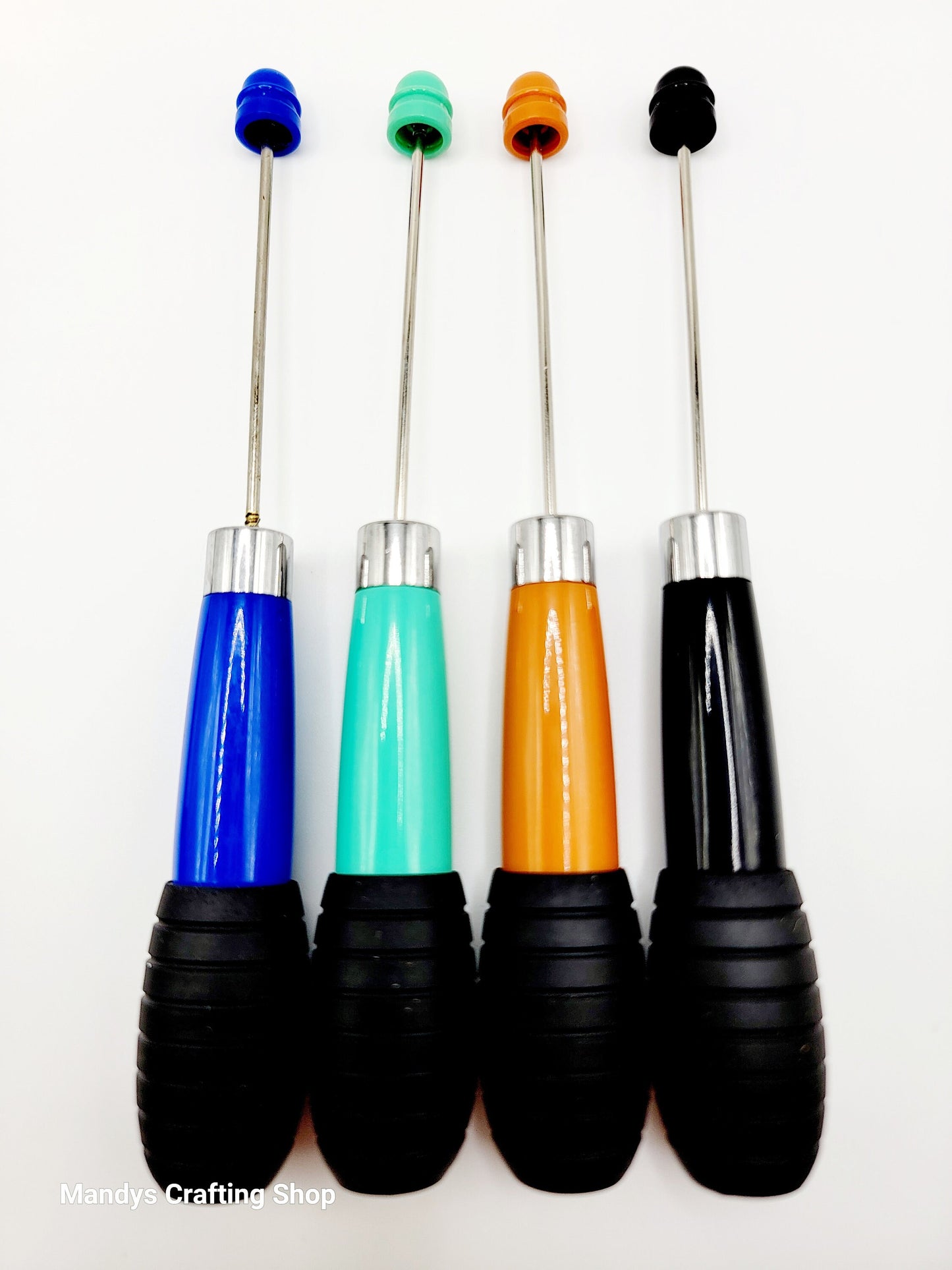 Four colorful tools with black handles on a white background