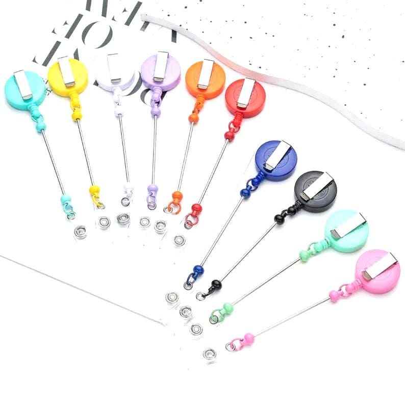 Set of colorful retractable badge holders on a white background