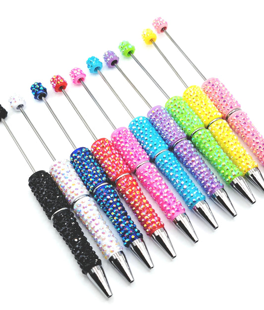 Colorful beaded pen tips on a white background