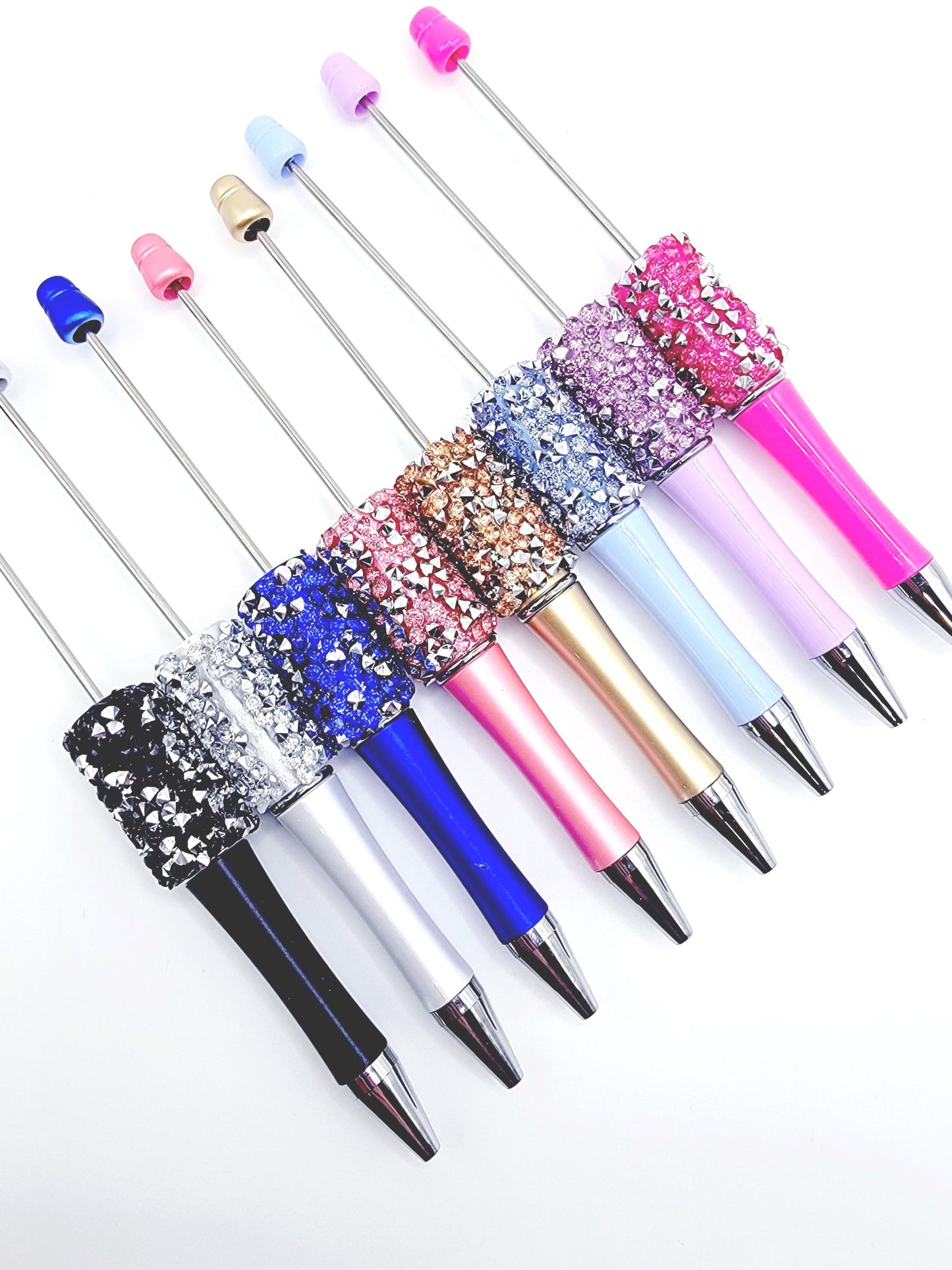 Set of colorful pens with glittery accents on a white background