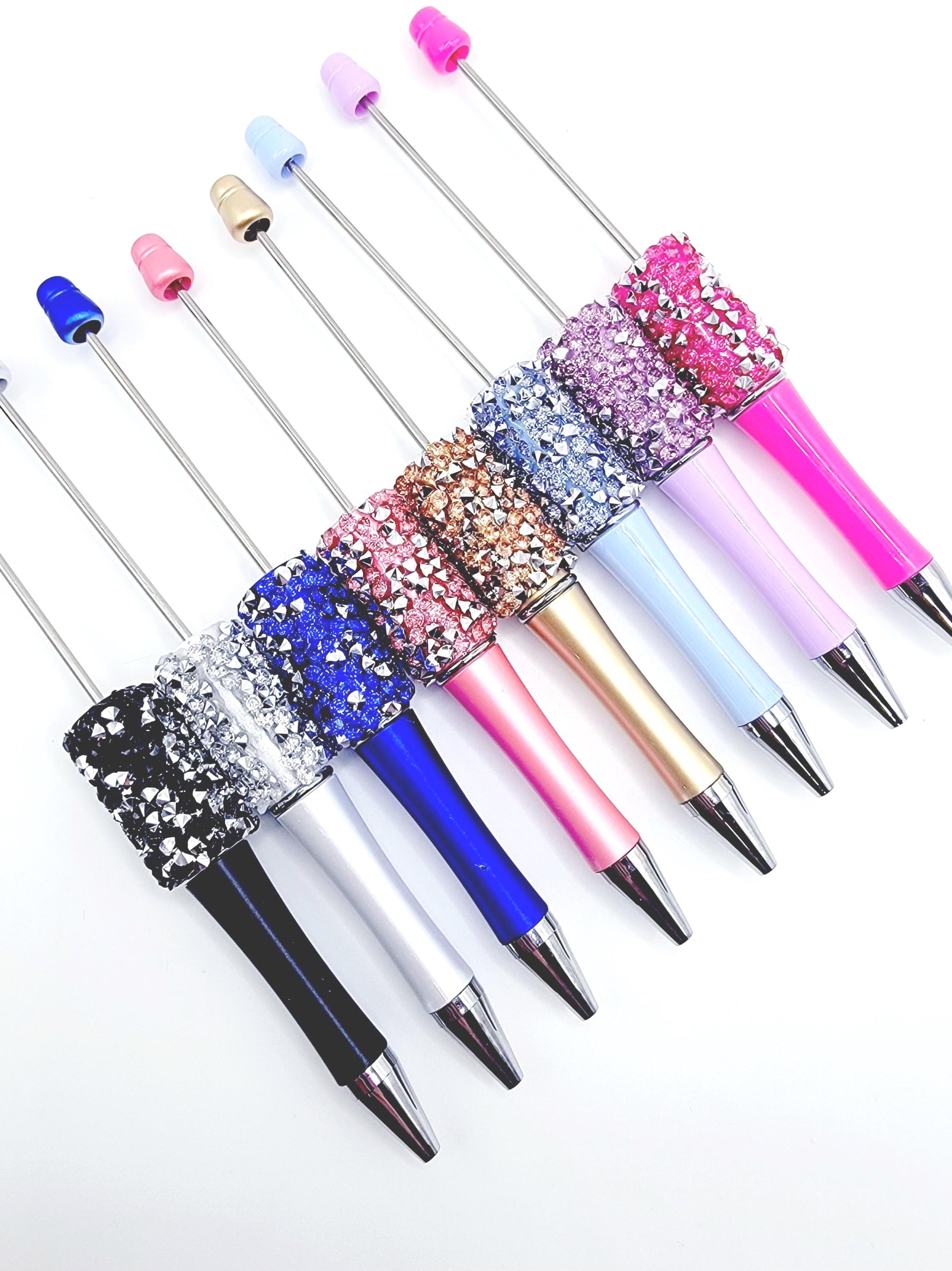Set of colorful pens with glittery accents on a white background