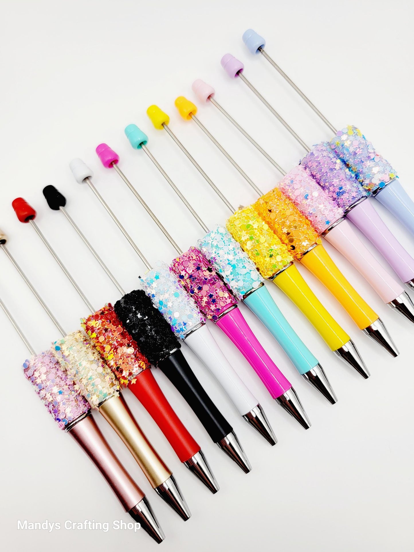 Colorful pens with glittery accents on a white background