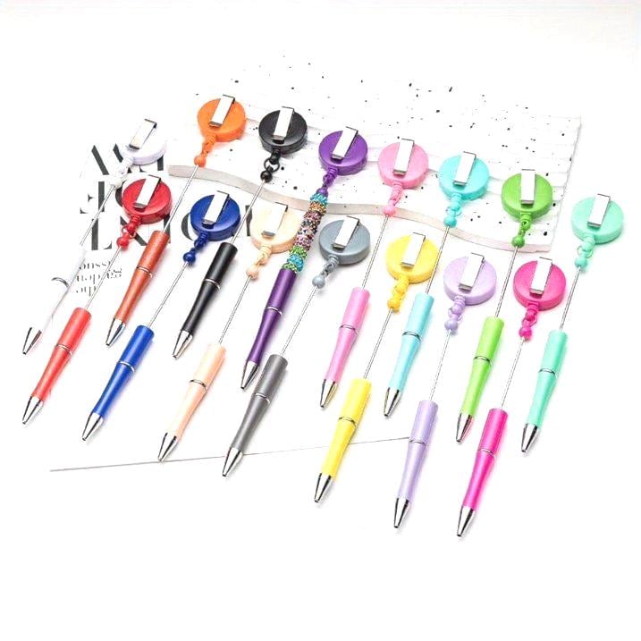 Assorted colorful pens with retractable clips on a white background