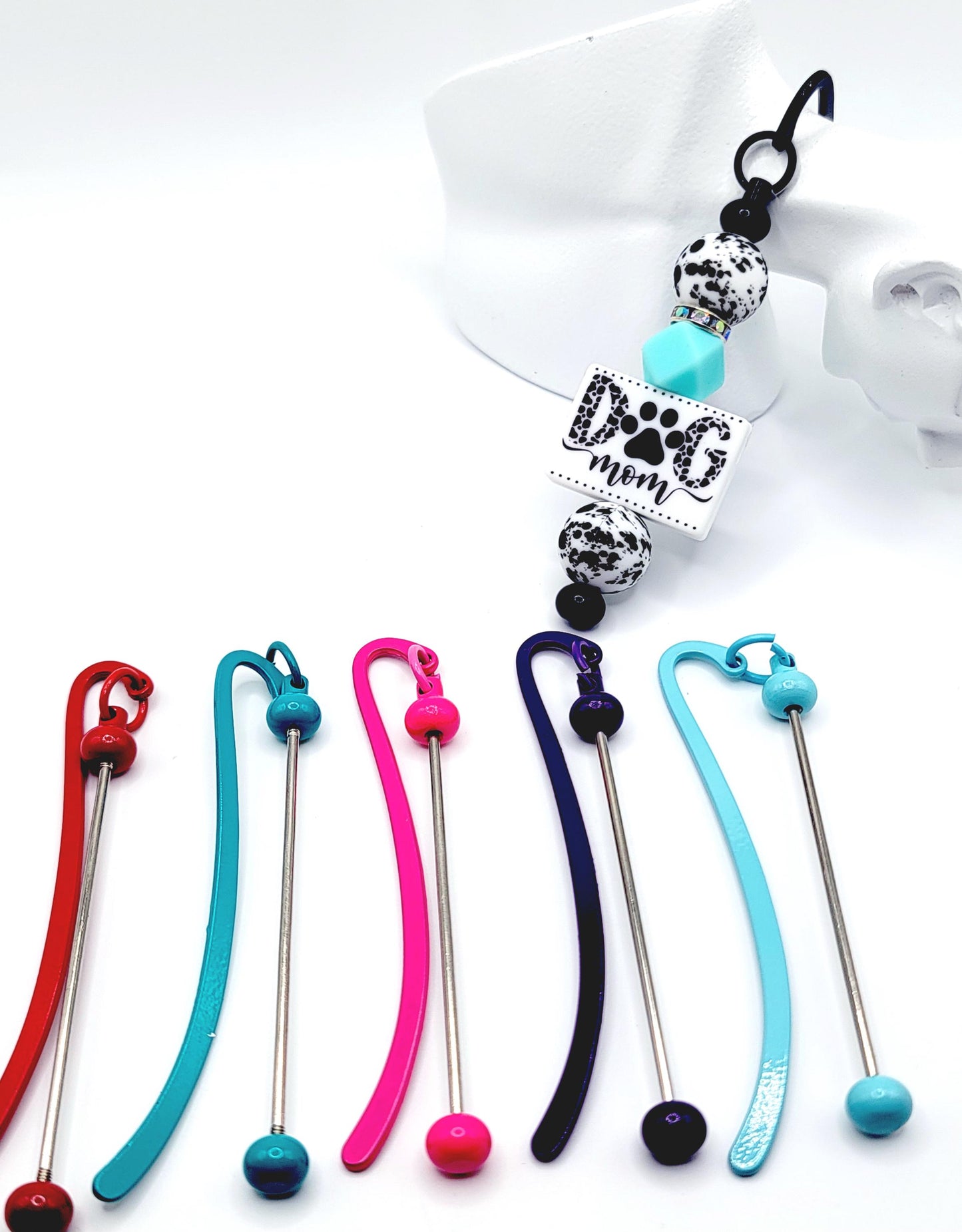 Colorful keychains with a 'Dog mom' charm on a white background