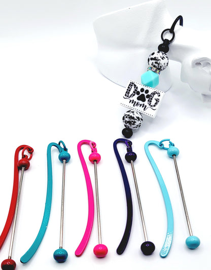 Colorful keychains with a 'Dog mom' charm on a white background