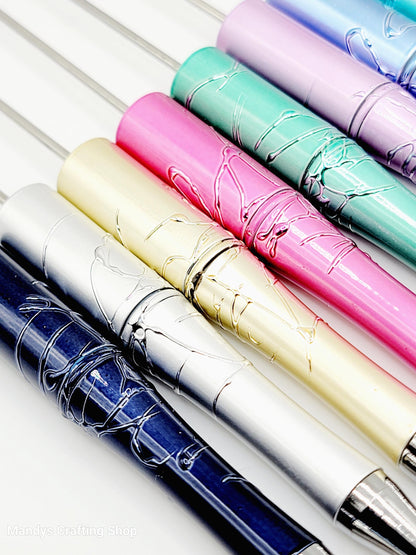 Set of colorful pens with metallic sheen on a white background