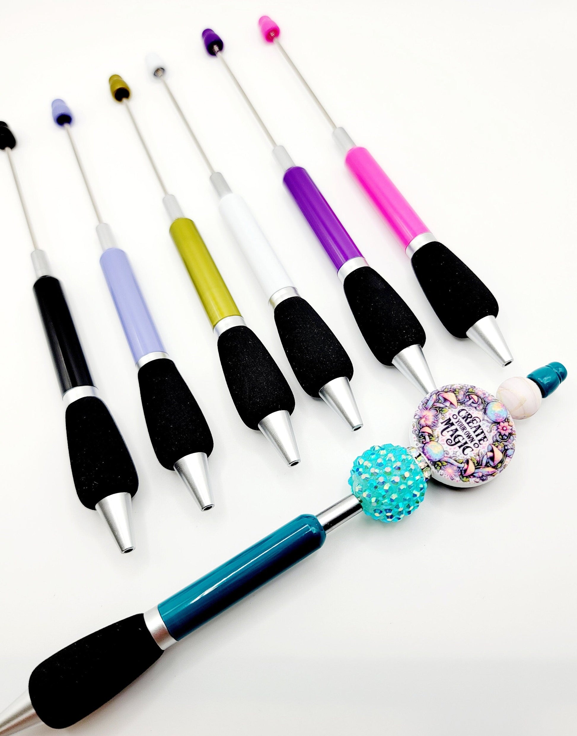 Set of colorful crafting tools with various attachments on a white background