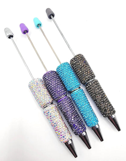 Set of four decorative pens with rhinestone embellishments on a white background