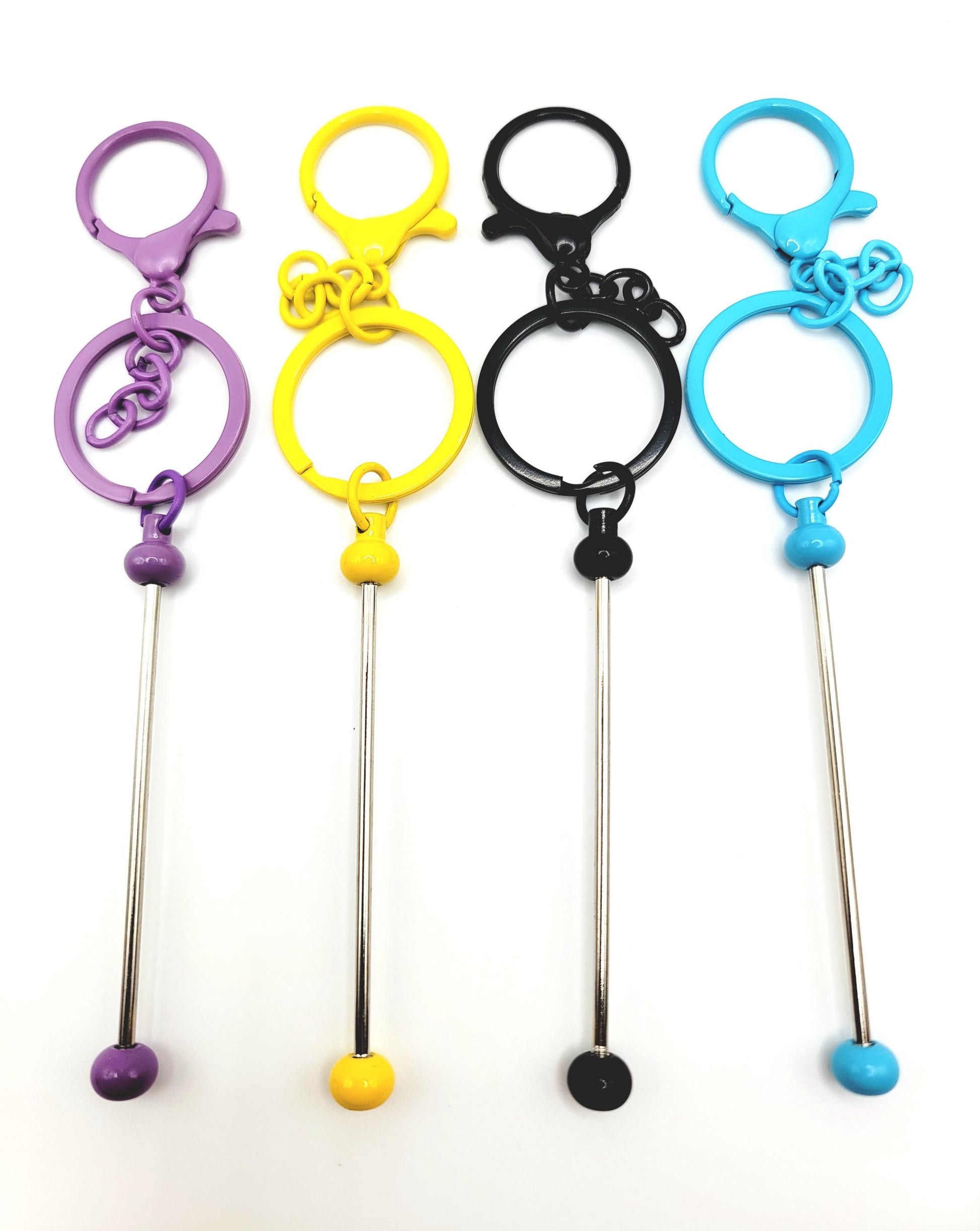 Set of four colorful keychain straws with different colored ends on a white background