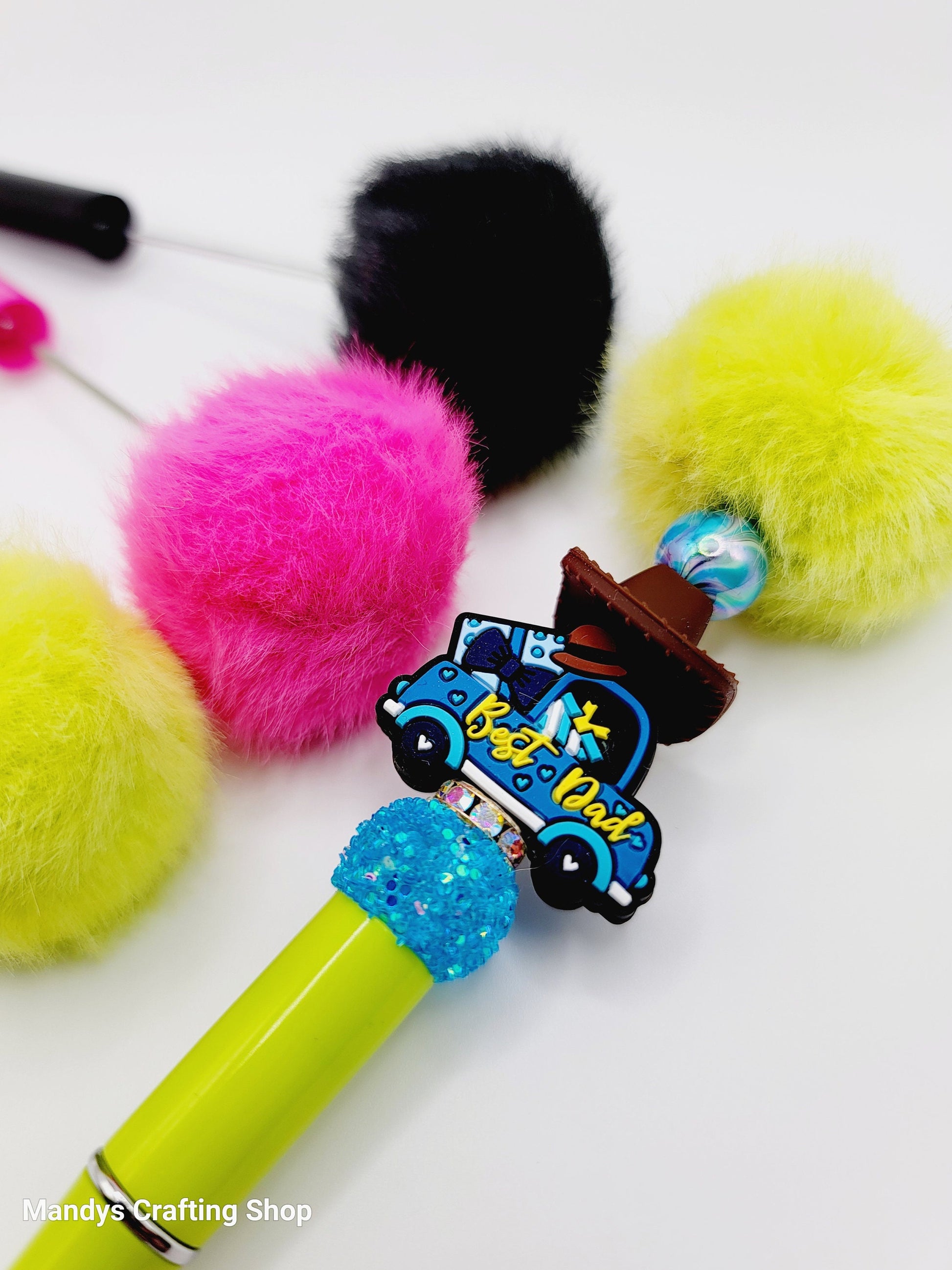 Colorful cat toy with pom-poms and a microphone on a white background