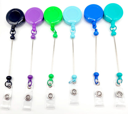 Set of colorful badge holders with retractable strings on a white background