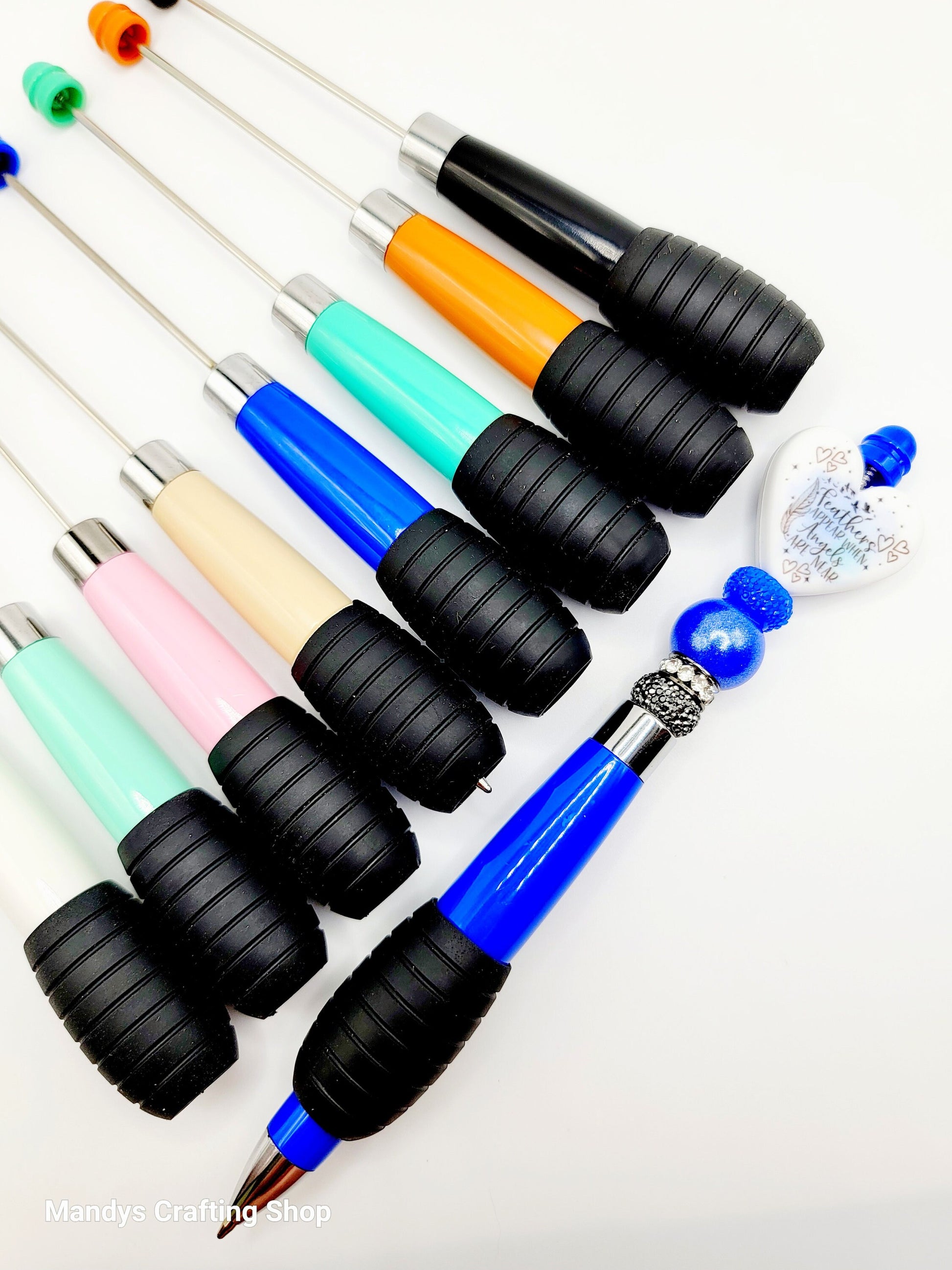 Set of colorful pens with black grips on a white background