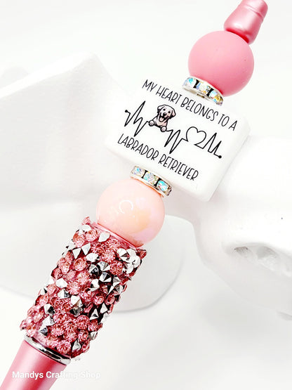 Pink and silver decorative item with text on a white background