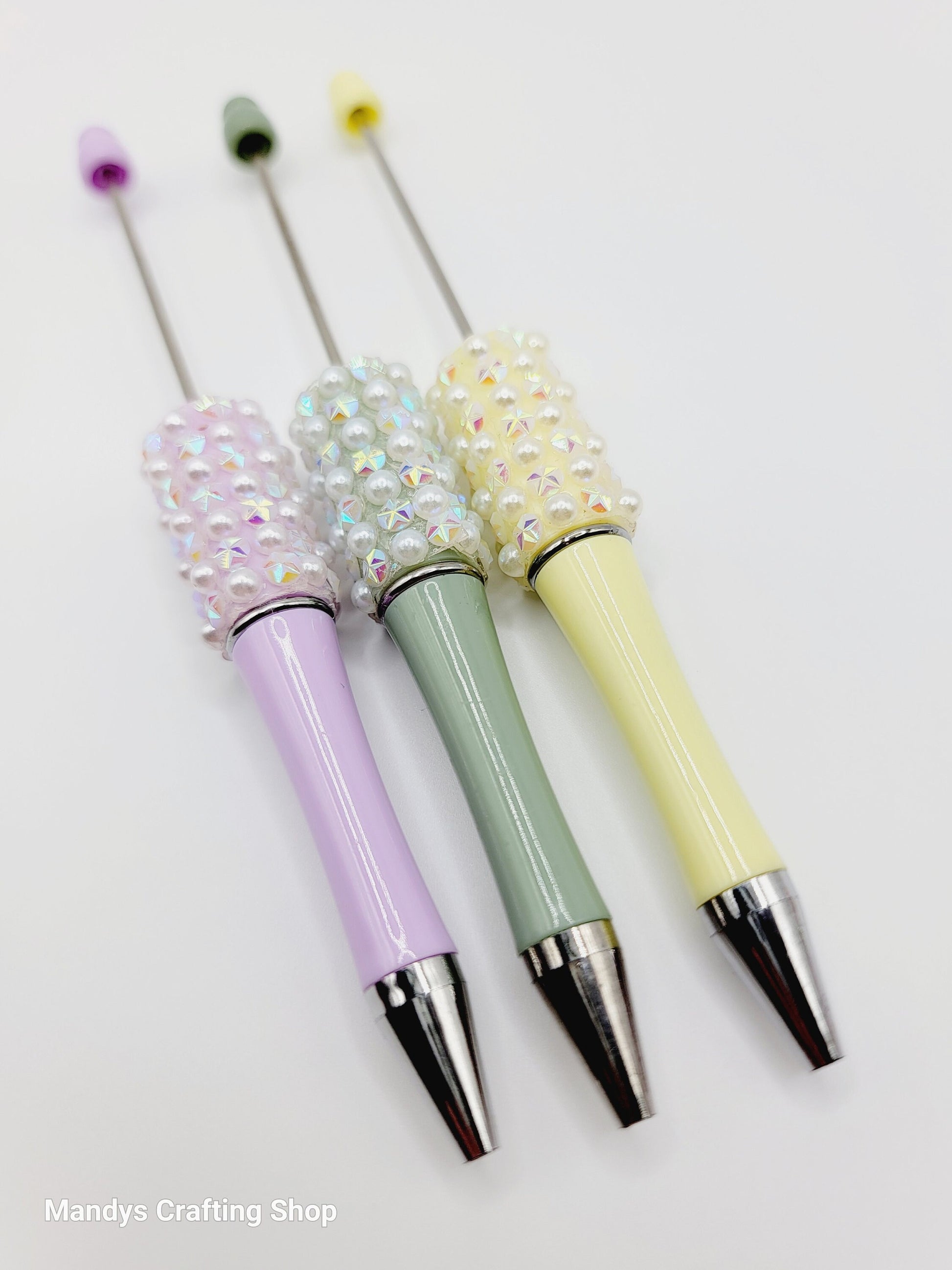 Three decorative pens with rhinestone accents on a white background, branded 'Mandy's Crafting Shop'.