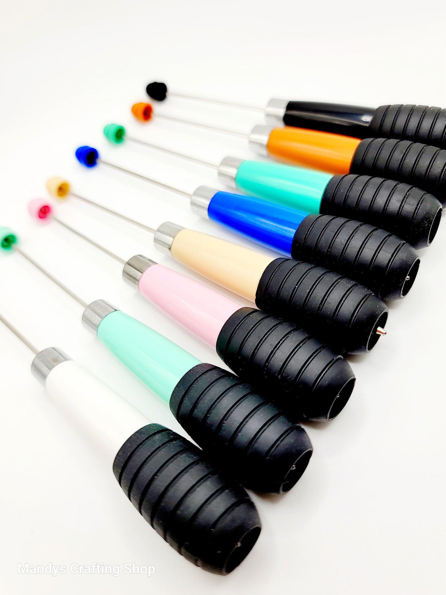Set of colorful pens with black shafts on a white background