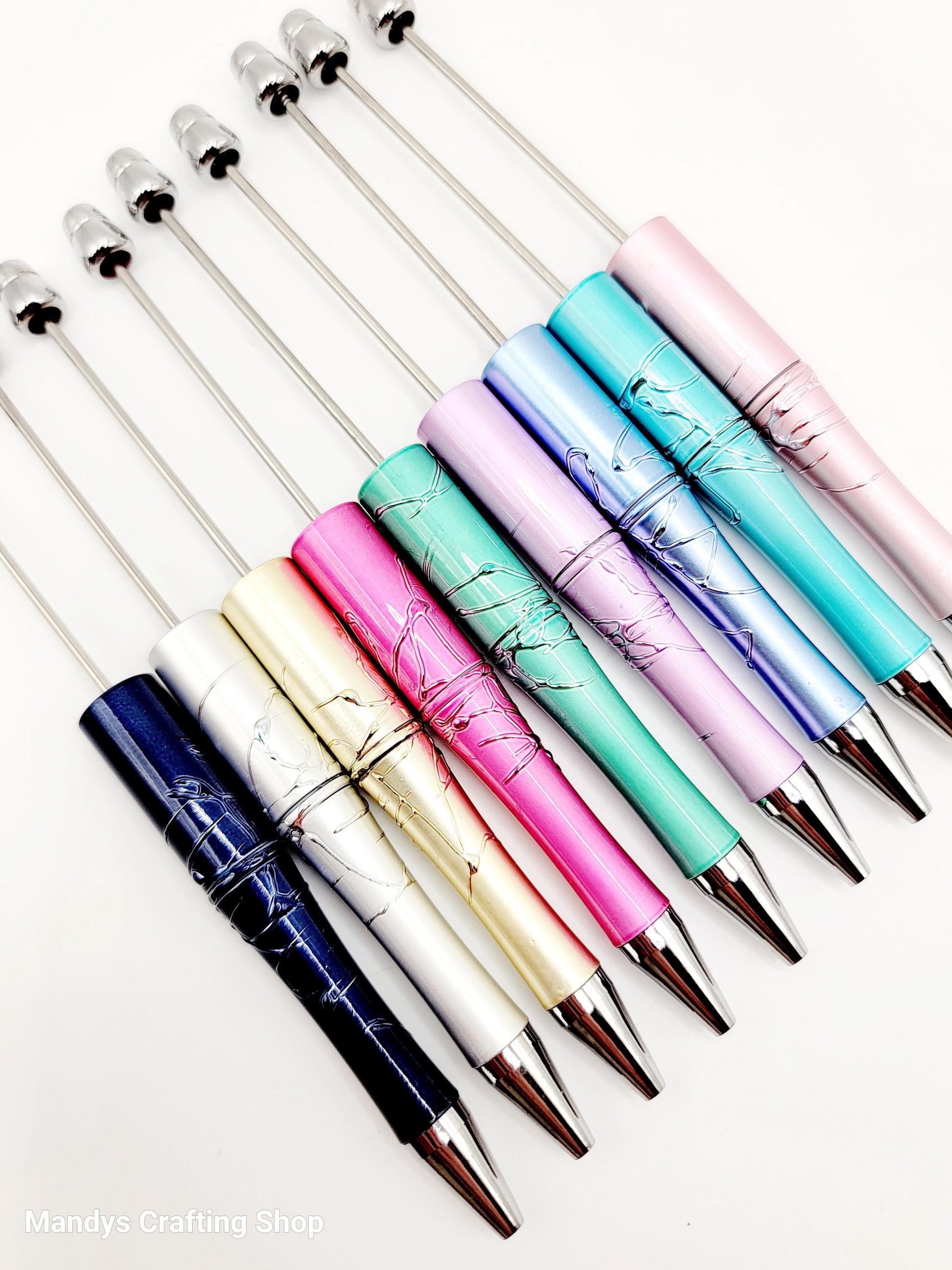 Set of colorful pens with metallic accents on a white background