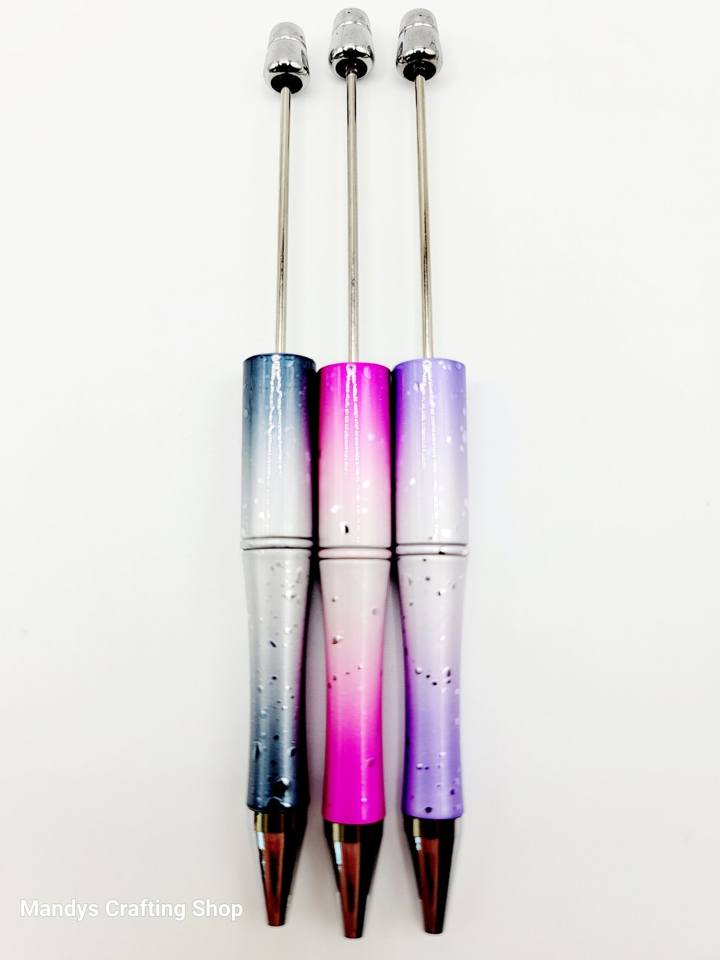 Three gradient pens with a blue, pink, and purple color scheme on a white background.