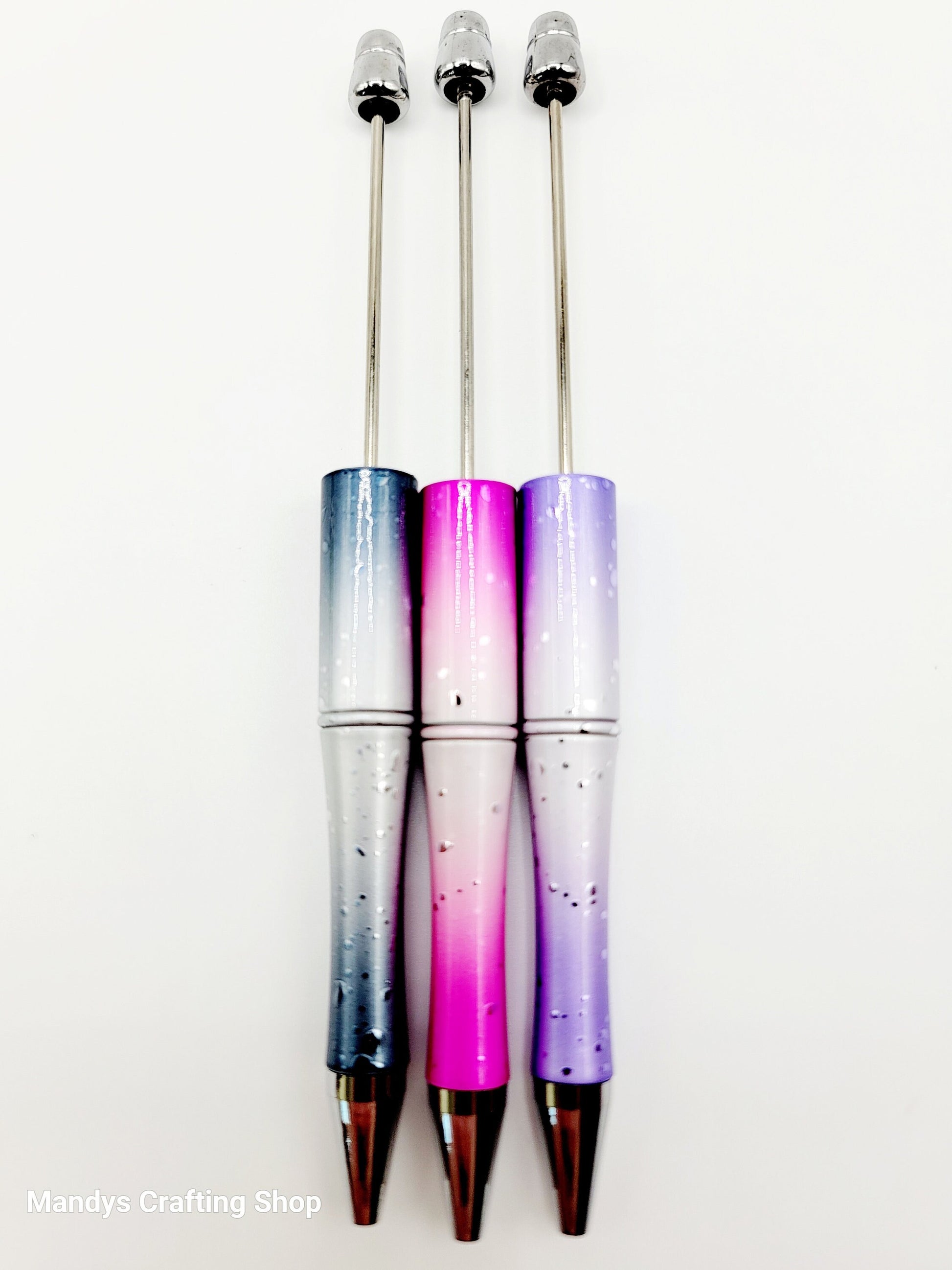 Three gradient pens with a blue, pink, and purple color scheme on a white background.