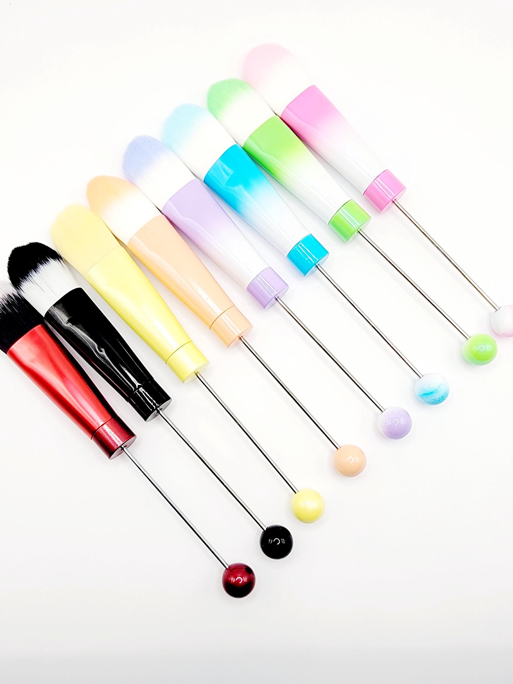 Set of colorful cocktail stirrers on a white background