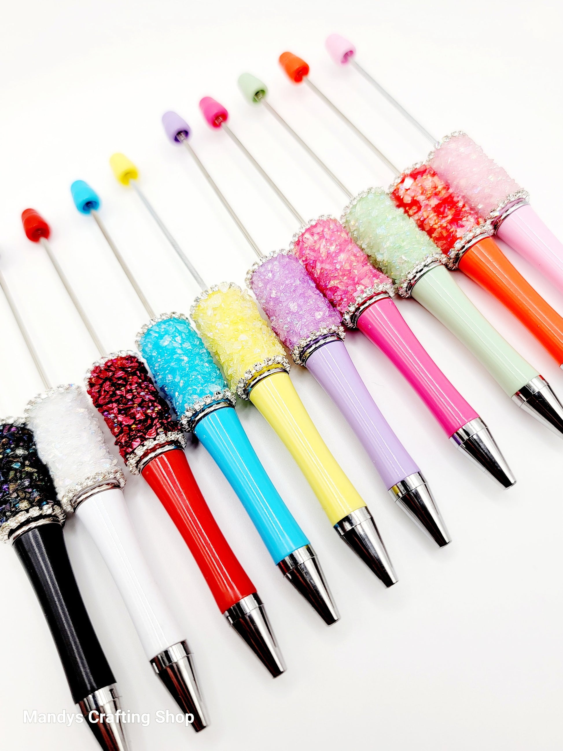 Colorful glittery pen tips on a white background