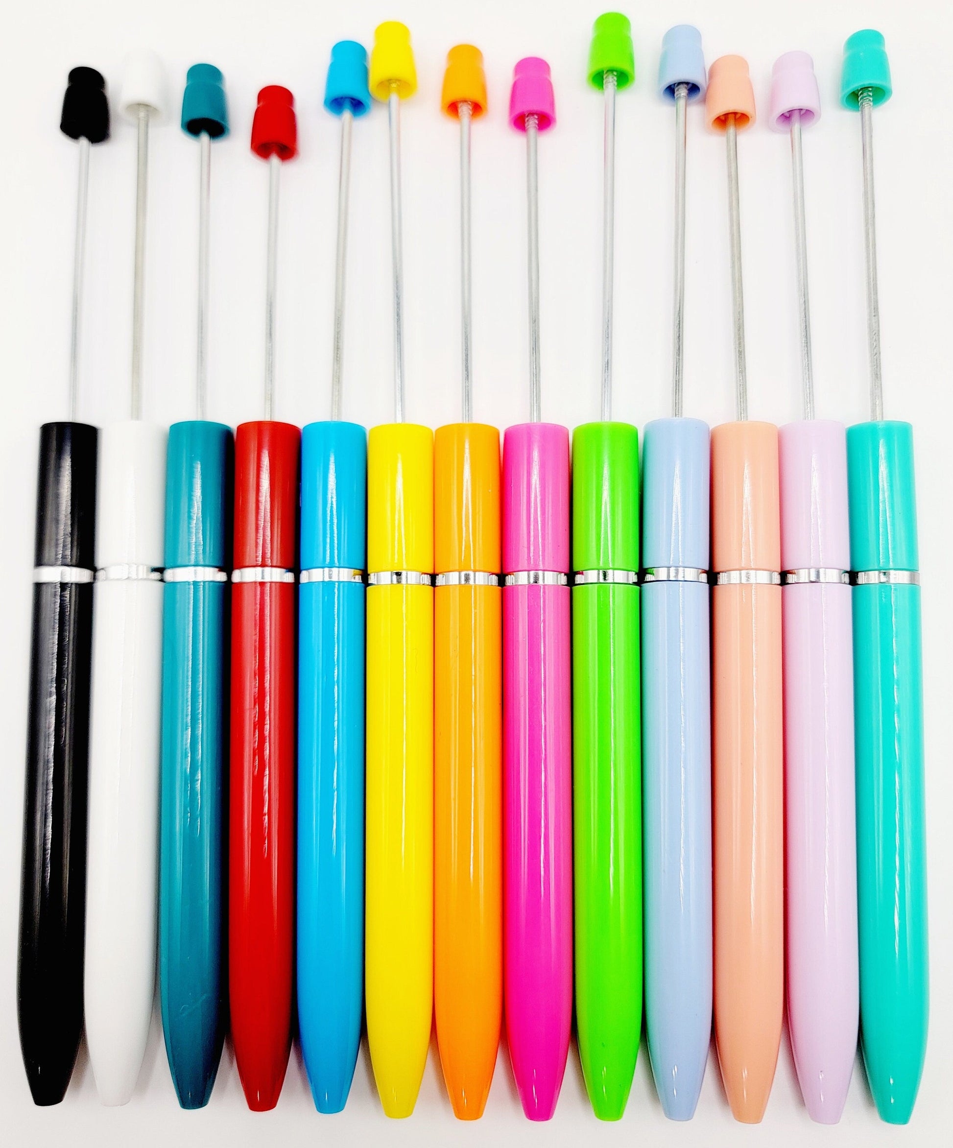 Colorful pens with various colored caps on a white background