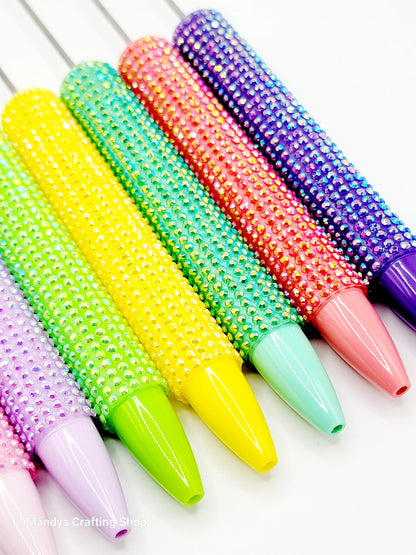 Colorful beaded rolling pins on a white background