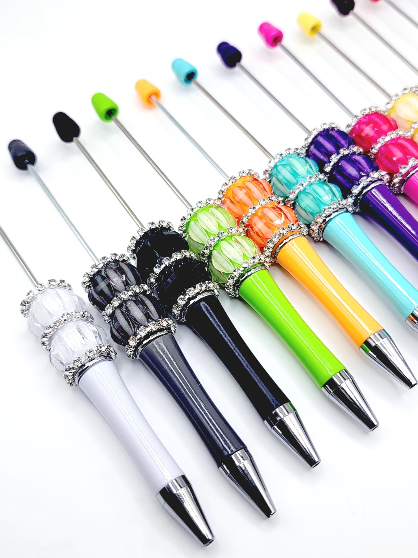 Set of colorful cocktail picks with decorative handles on a white background