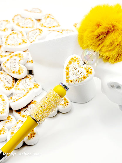 Yellow pen with decorative handle on a white background