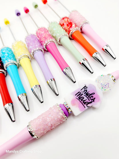 Colorful pens with decorative caps on a white background