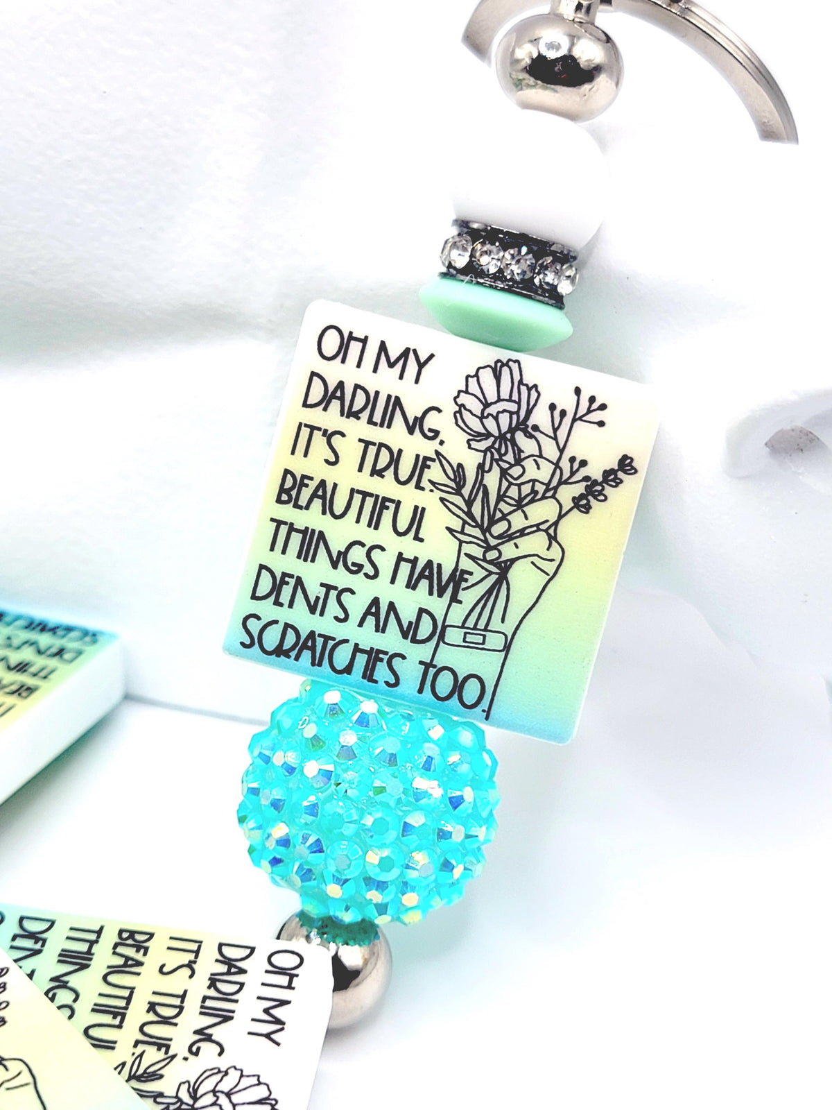 Keychain with a colorful tag and decorative elements on a white background