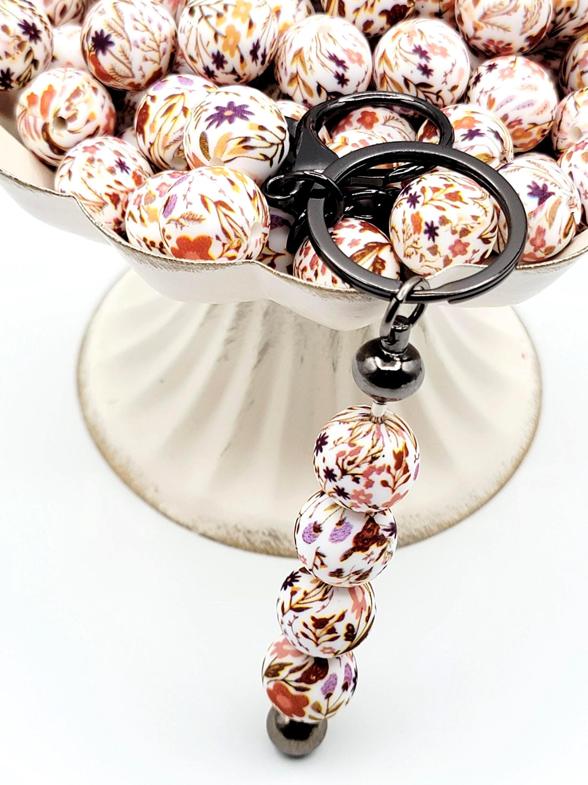 15mm brown floral print silicone round beads with autumn-inspired flower designs for pens, wristlets, keychains, jewelry, and crafts.
