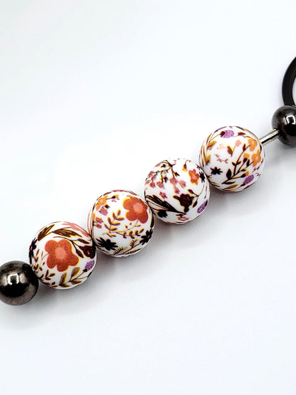 15mm brown floral print silicone round beads with autumn-inspired flower designs for pens, wristlets, keychains, jewelry, and crafts.